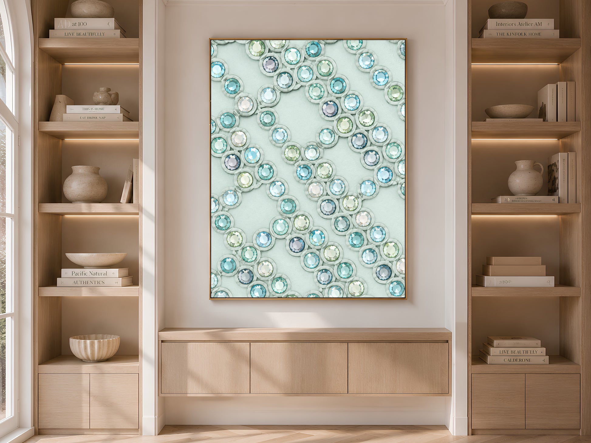 Crystal gemstone wall art framed above a console table between built-in bookshelves