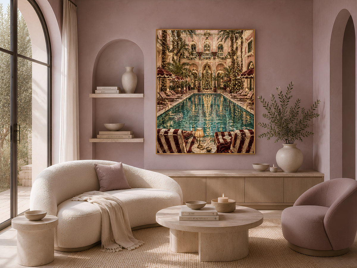 Grand hotel Christmas print framed above a curved boucle sofa in a warm neutral living room