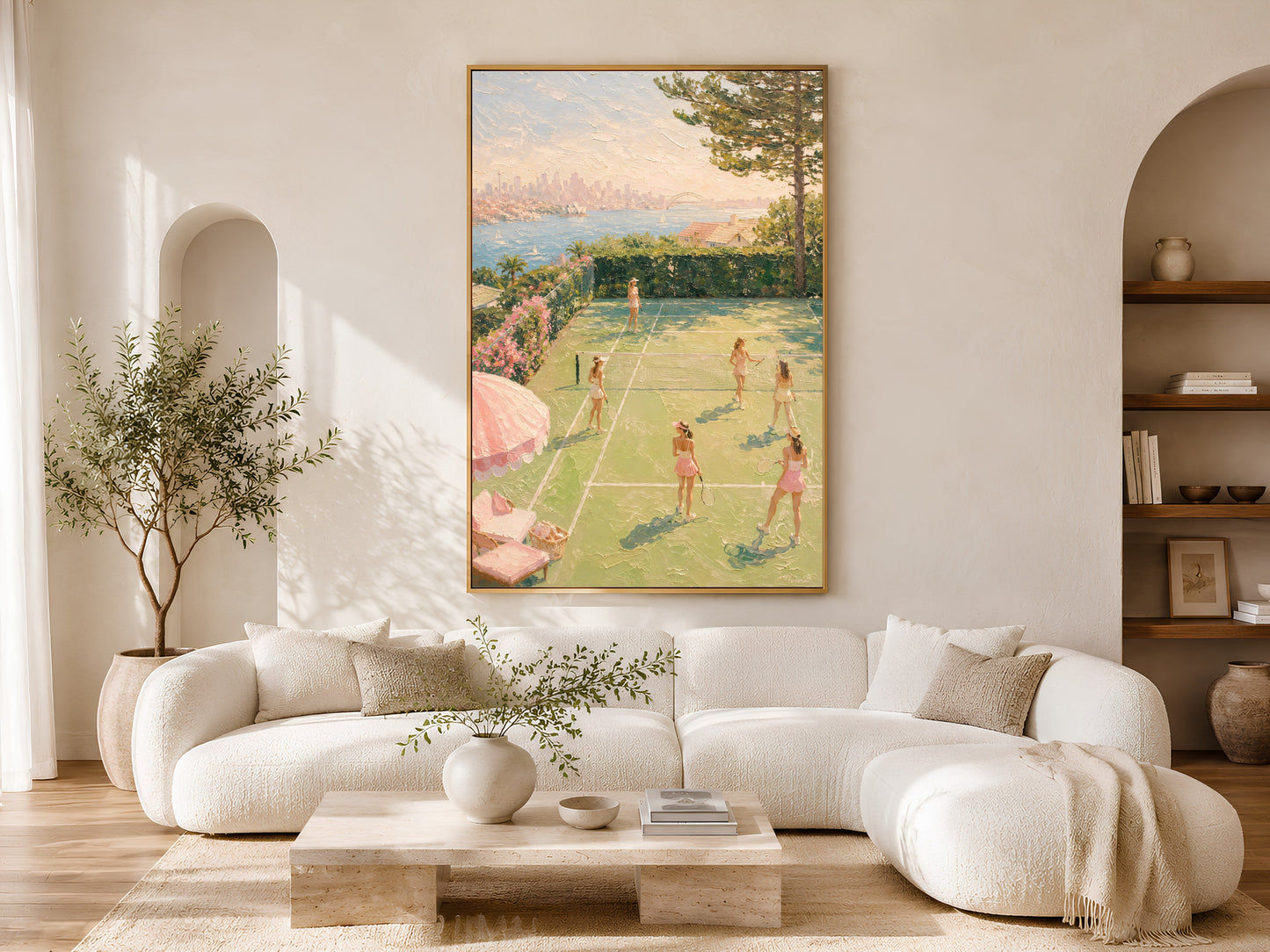 Country club tennis wall art in gold frame above a cream sofa in a bright neutral living room with arched shelving