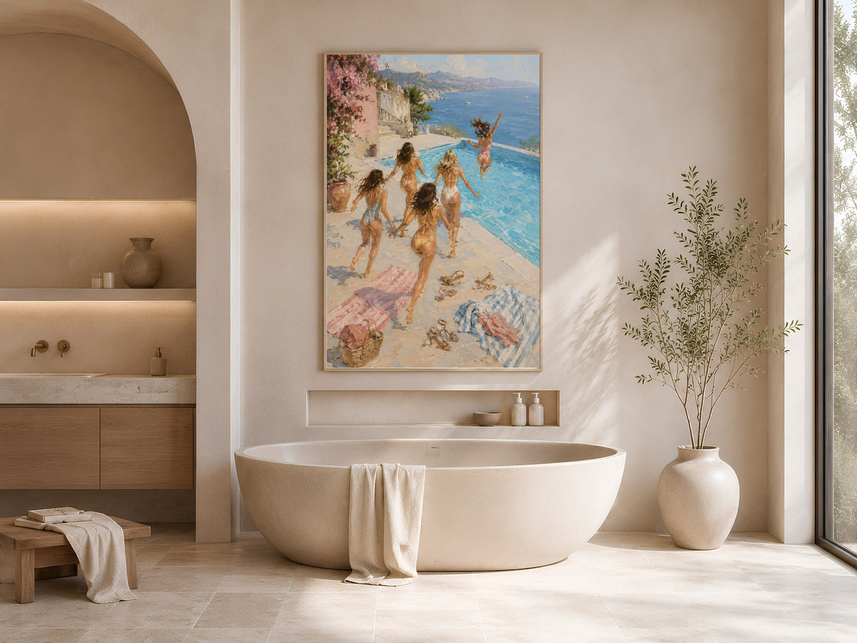 Girls trip pool print framed on a wall above a bathroom vanity with candles and towels