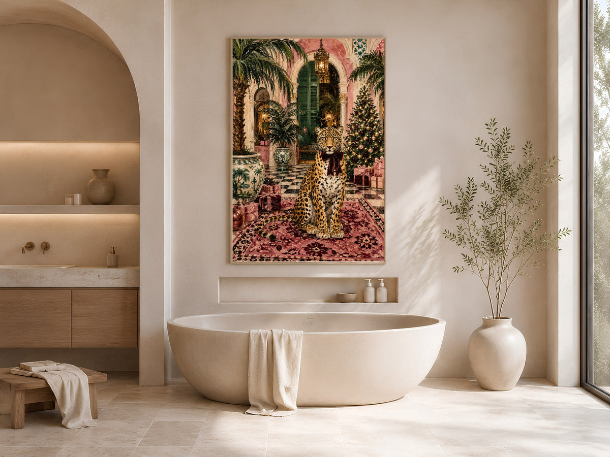 Pink palazzo Christmas painting framed above an oval soaking tub in a neutral arched bathroom