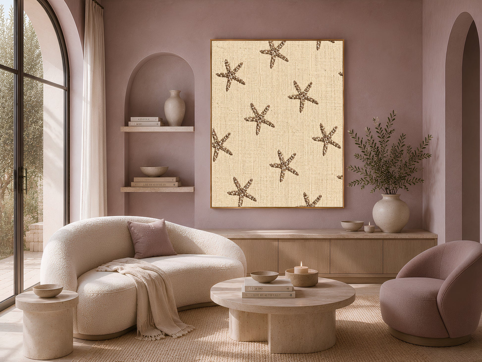 Embroidered starfish wall art framed on a mauve wall above a cream sofa and accent chairs