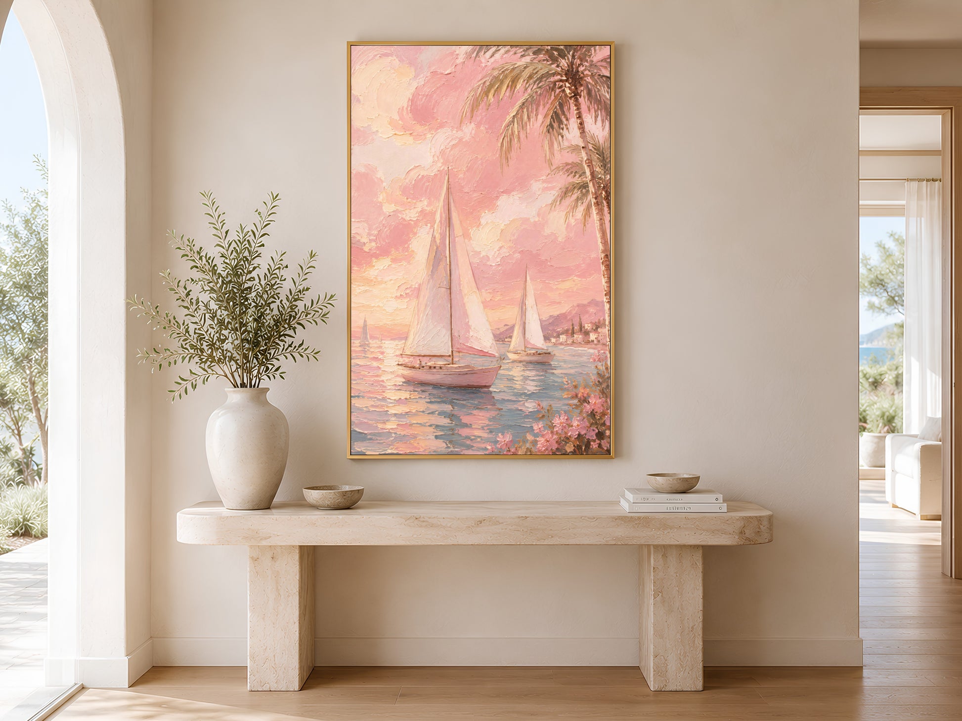Pink tropical sailboat print in gold frame above a marble console table in a minimal bright neutral hallway