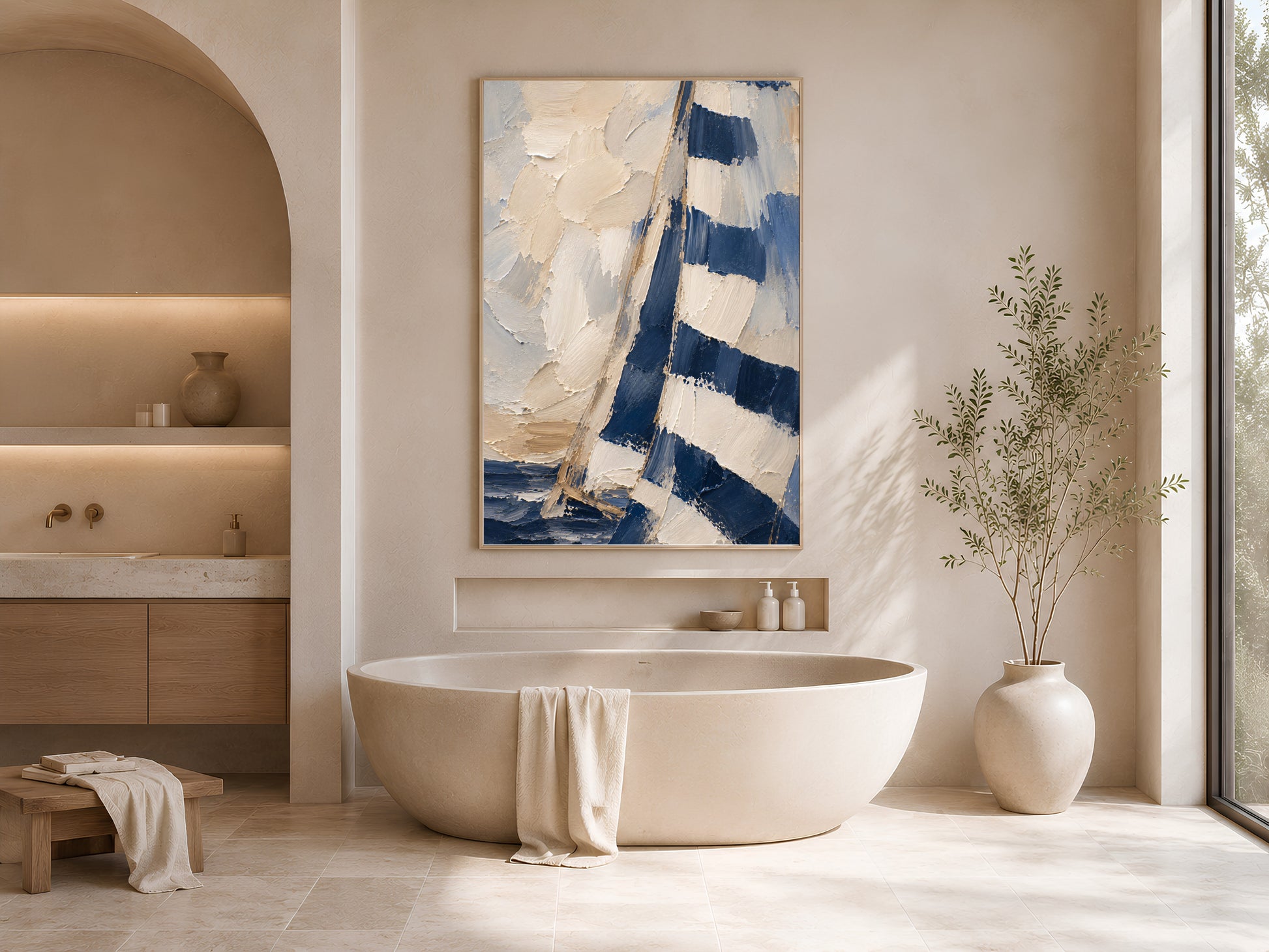 Navy sailboat wall art print framed above a freestanding tub in a warm neutral bathroom