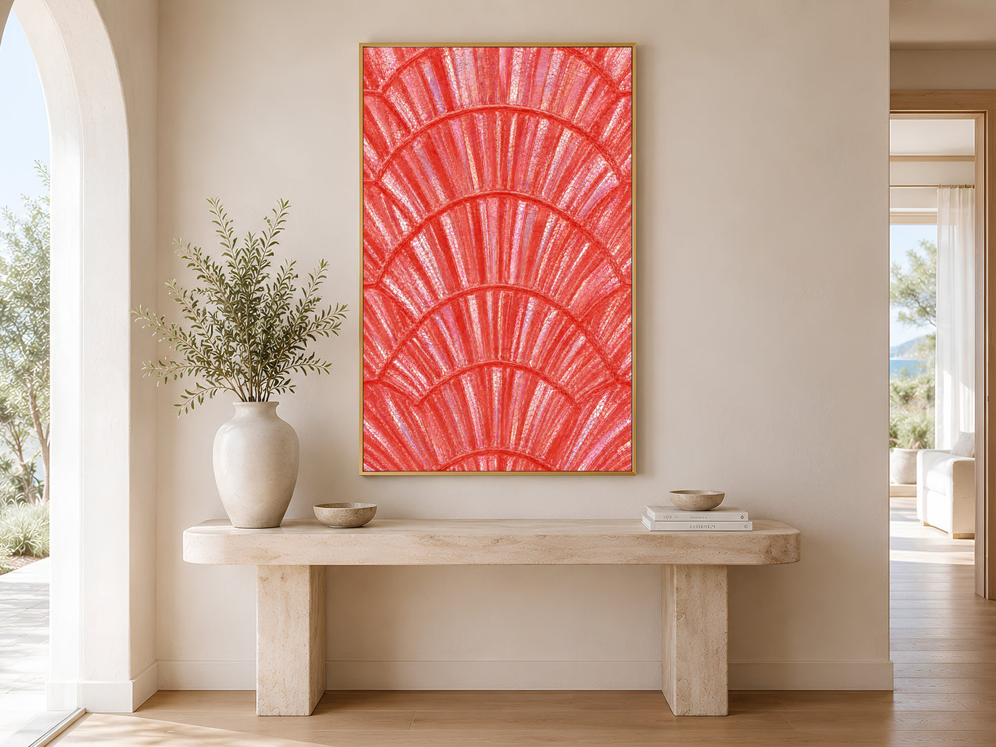 Coral iridescent shell print in gold frame above a console table in a minimal bright neutral hallway with ceramic vase
