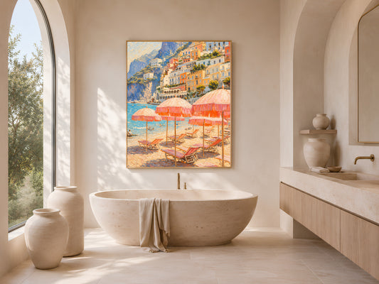 Bright bathroom with a freestanding soaking tub and arched window, framed Amalfi Coast beach umbrella wall art hanging on the wall beside it.
