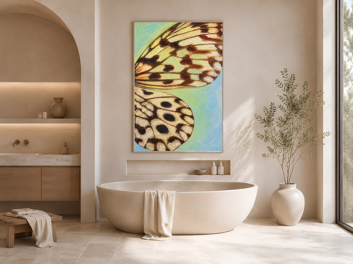 Teal gradient butterfly wing print framed above a freestanding tub in a warm neutral bathroom