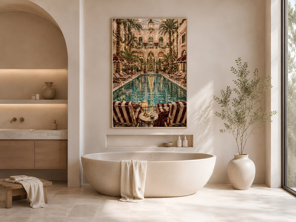 Palm court Christmas print framed above an oval soaking tub in a neutral arched bathroom