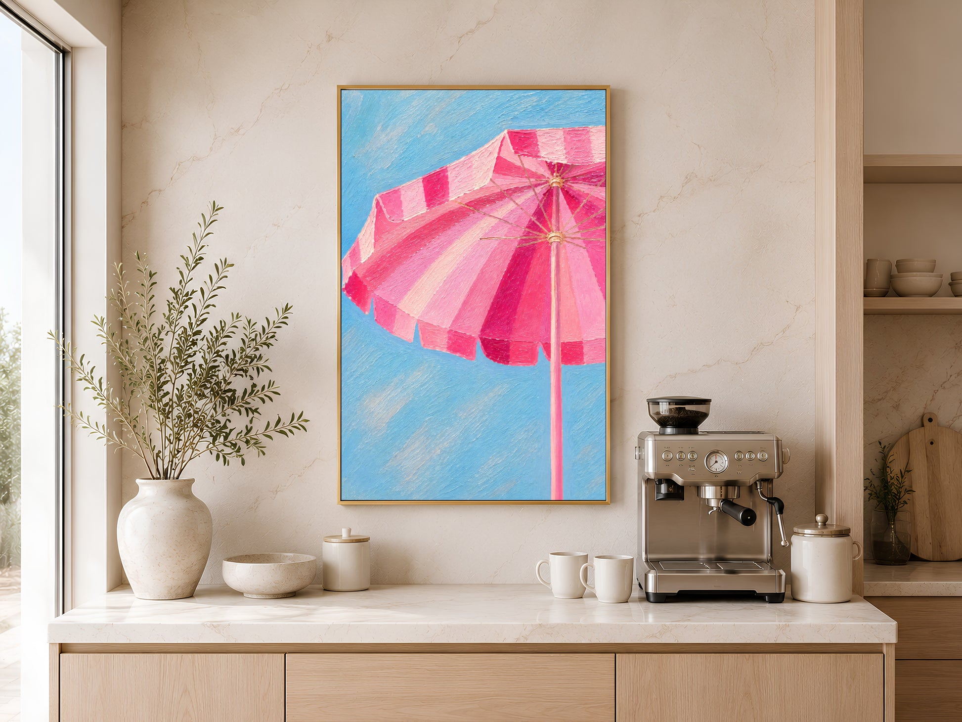 Preppy coastal umbrella wall art printable displayed above a coffee station in a warm minimalist kitchen with natural light and organic styling.