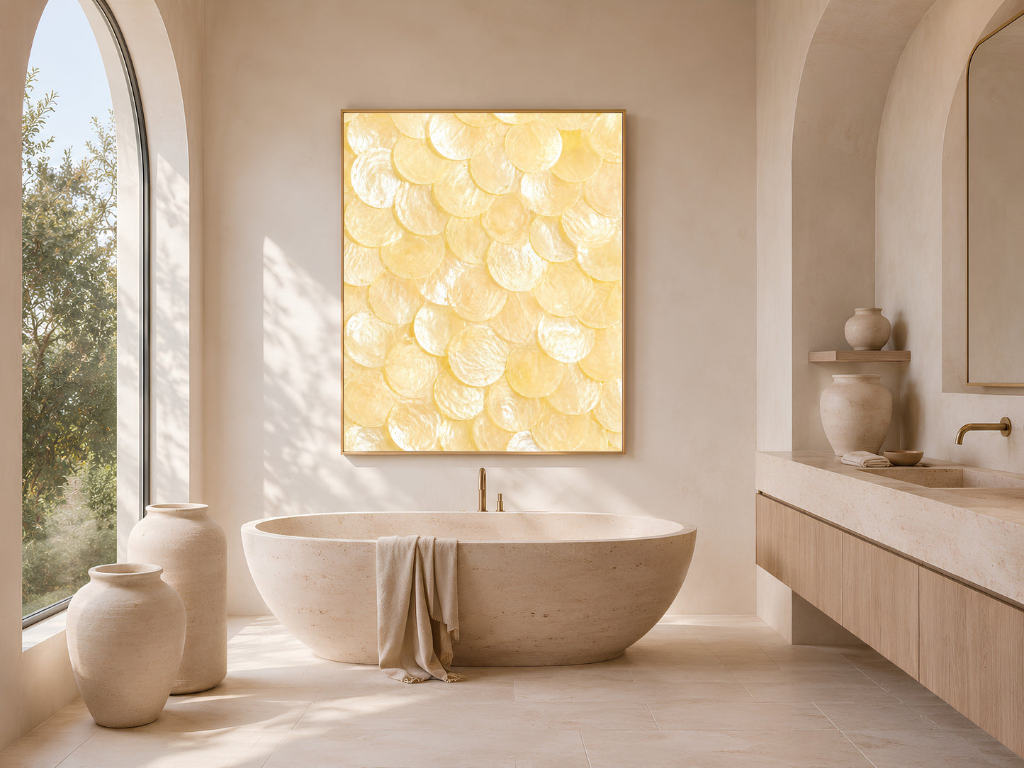 Capiz shell wall art in a gold frame above a freestanding soaking tub in a warm neutral bathroom with arched window light
