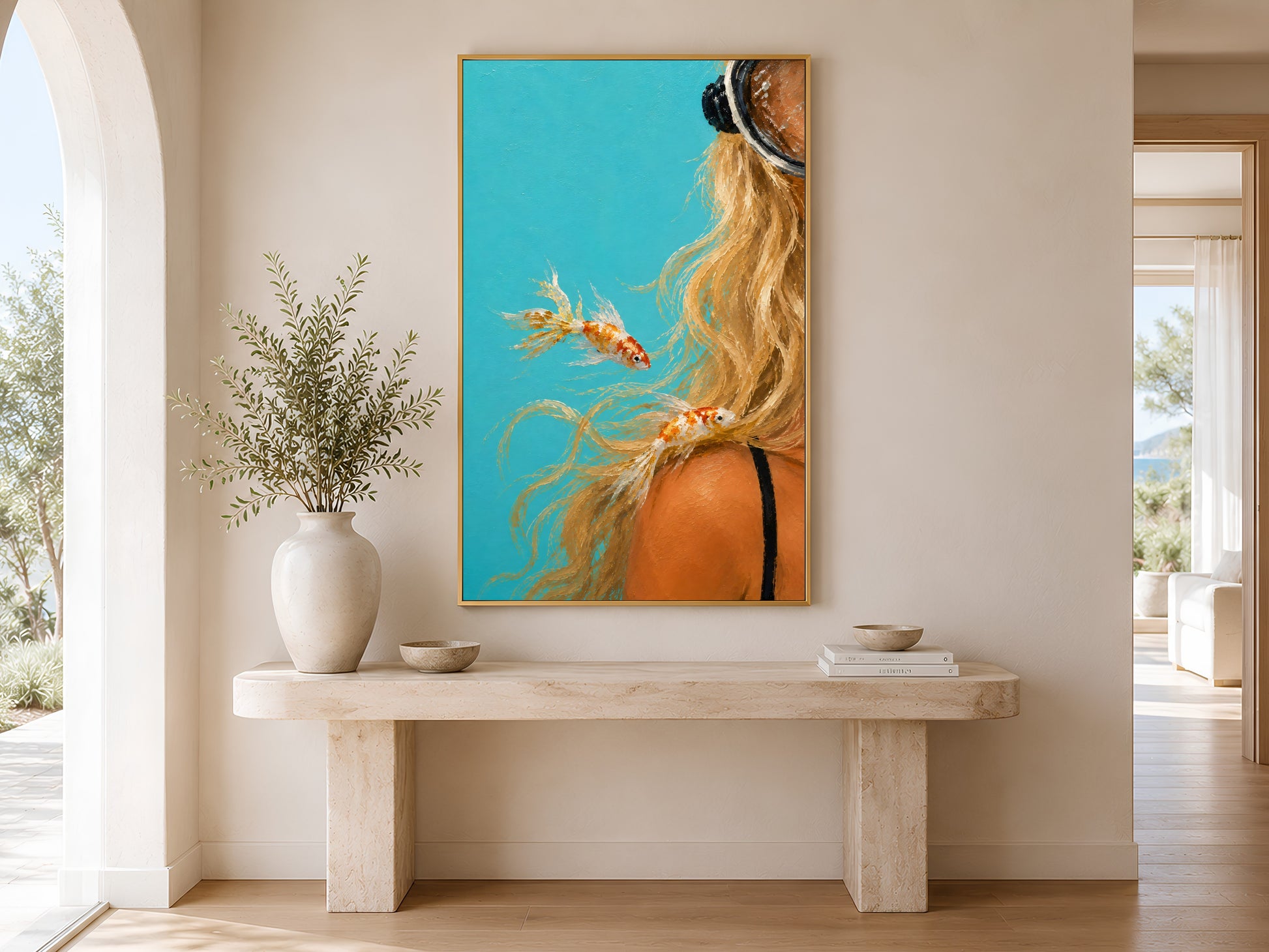 Turquoise diver girl print in gold frame above a console table in a bright neutral hallway with arched doorway