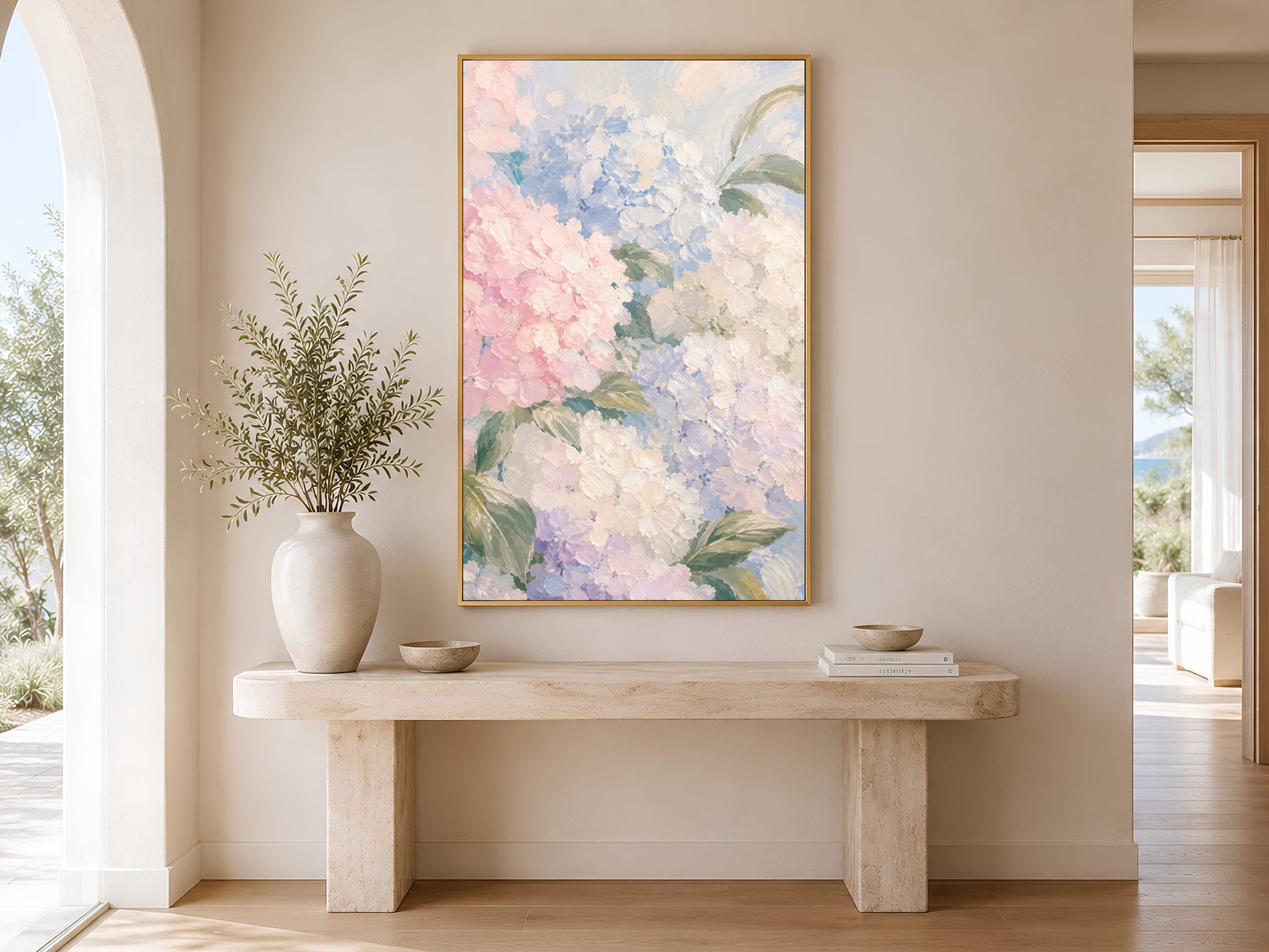 Hydrangea botanical print in gold frame above a marble console table in a minimal bright neutral hallway