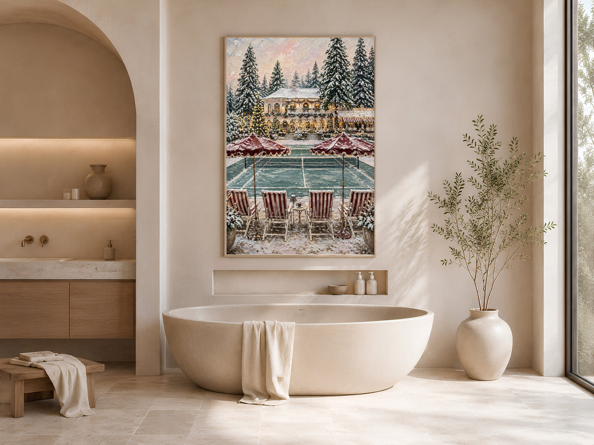 Framed Christmas tennis court painting displayed above an oval soaking tub in a neutral arched bathroom