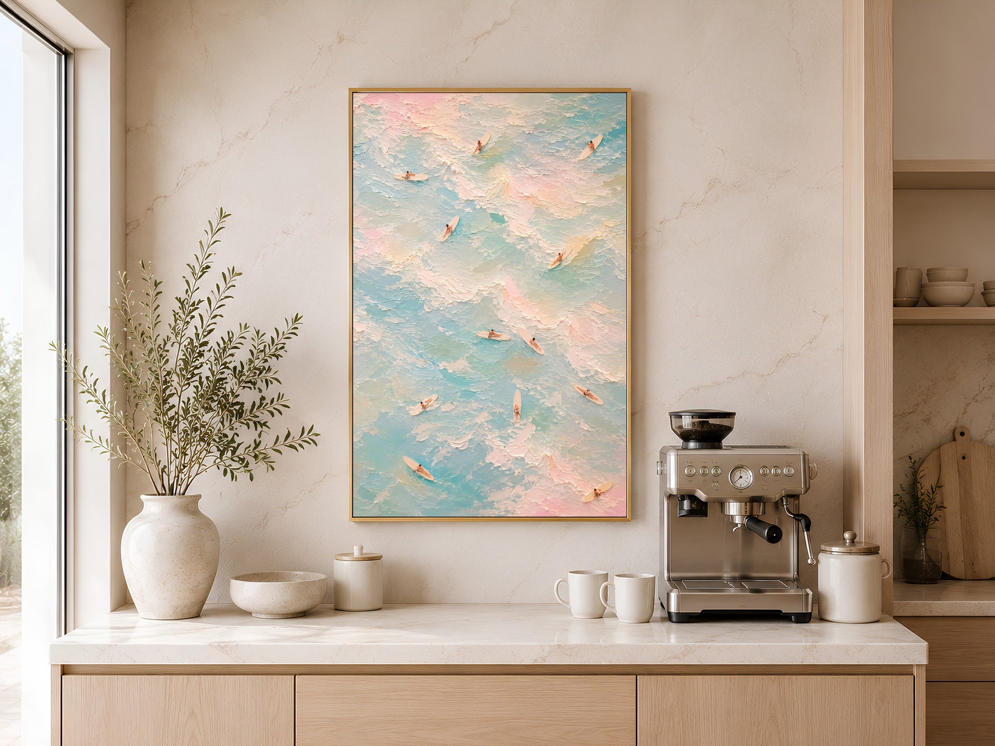 Pastel surf poster in gold frame above a wooden sideboard with coffee machine in a warm minimal kitchen