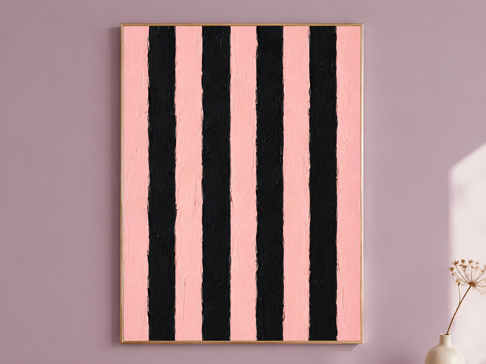 Bold pink and black stripe impasto wall art in gold frame on mauve wall with dried flower stems
