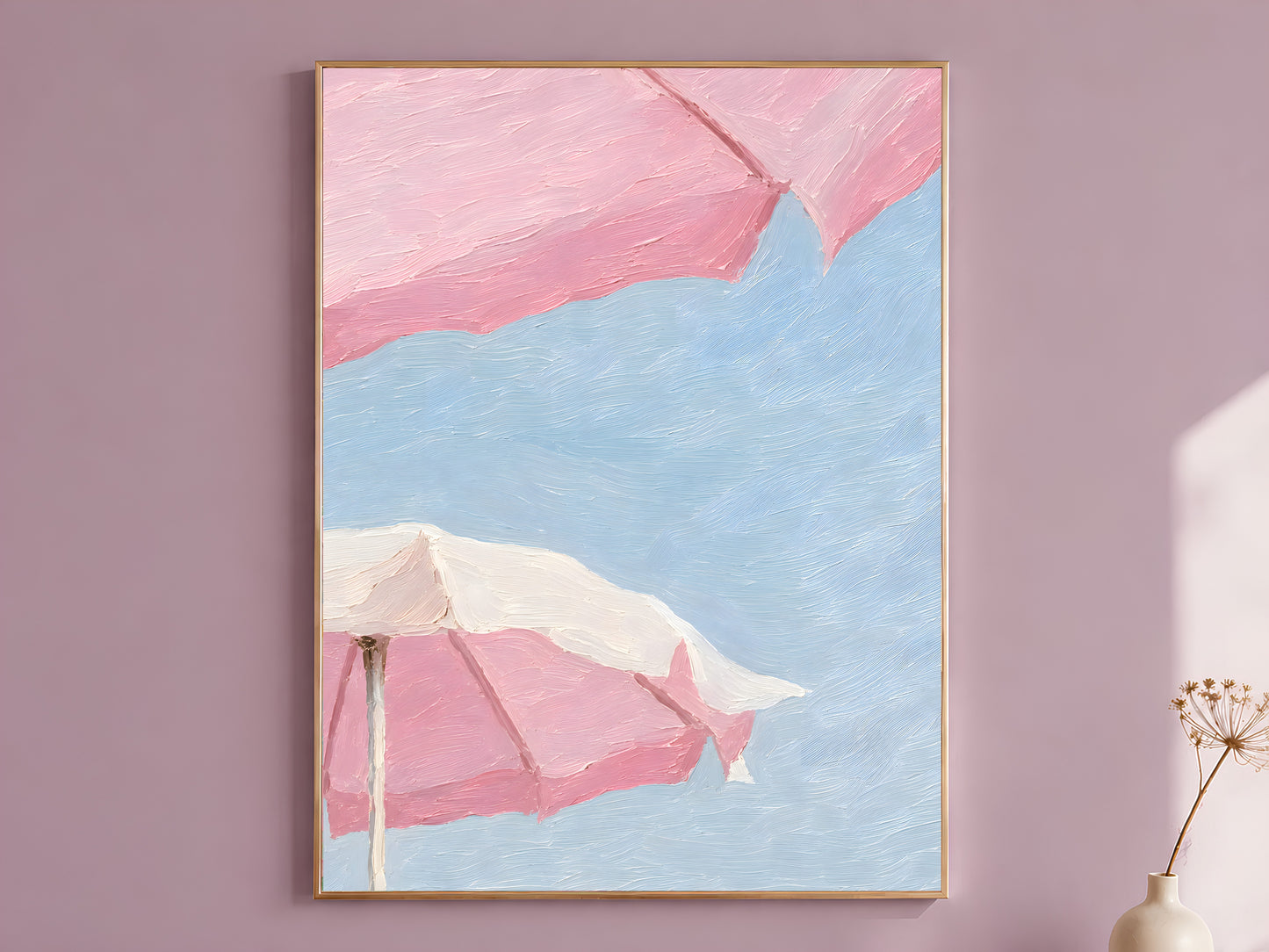 Impasto oil painting style pink beach umbrella wall art print in a thin wood frame displayed against a dusty mauve wall, showing oversized bubblegum pink umbrellas and a cream umbrella against a powder blue sky