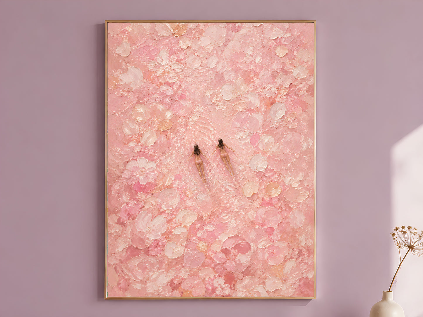 Pink impasto oil painting style wall art in a gold frame hanging on a dusty mauve wall beside a dried allium stem, showing two tiny swimmer figures surrounded by thick chalky blush and cream brushstroke blooms
