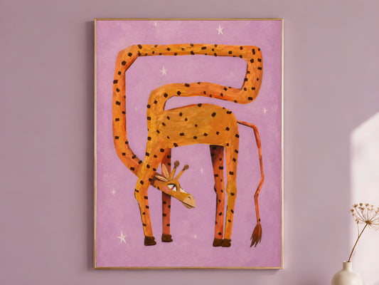 Whimsical giraffe wall art in a gold frame on a dusty mauve wall with a dried allium stem, showing a surreal orange and amber spotted giraffe bending its long neck into a full loop with its head tucked between its legs against a lilac background with white stars
