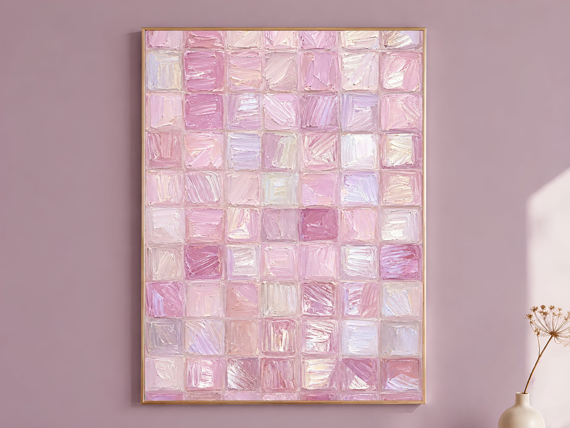 Pink impasto mosaic tile grid wall art in gold frame on mauve wall with dried flower stems
