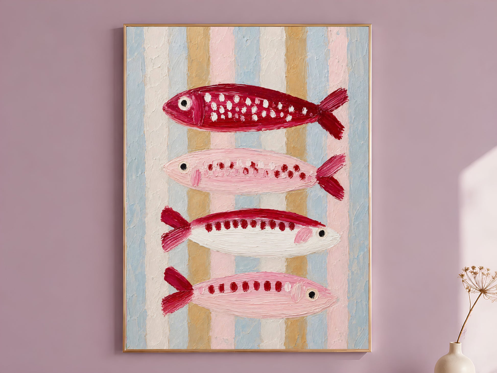 Pink and red impasto sardine wall art in a gold frame on a dusty mauve wall with a dried allium stem, showing four stacked fish in crimson, blush, and cream against a pastel striped background in blue, gold, and pink
