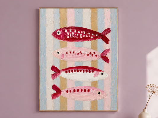 Pink and red impasto sardine wall art in a gold frame on a dusty mauve wall with a dried allium stem, showing four stacked fish in crimson, blush, and cream against a pastel striped background in blue, gold, and pink
