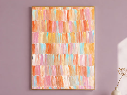 Colorful brushstroke mosaic wall art print in a wood frame displayed on a dusty mauve wall with dried florals