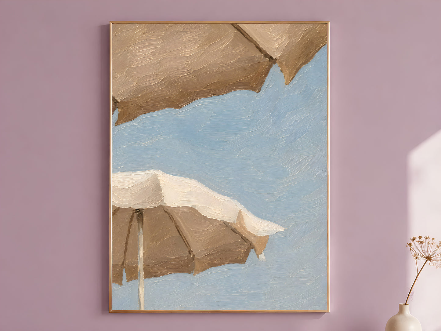 Impasto oil painting style beach umbrella wall art print in a thin wood frame displayed against a dusty mauve wall, showing two oversized cream and taupe umbrellas against a powder blue sky

