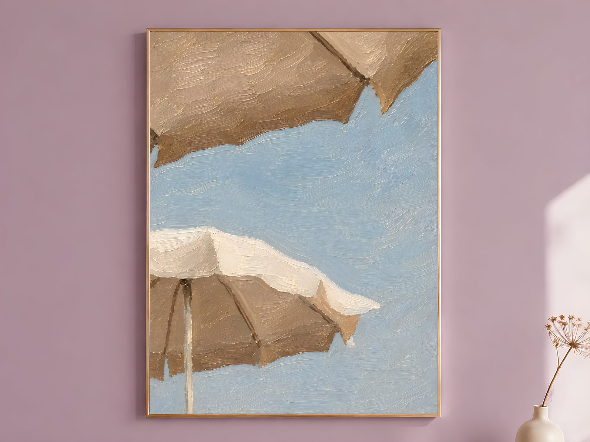 Impasto oil painting style beach umbrella wall art print in a thin wood frame displayed against a dusty mauve wall, showing two oversized cream and taupe umbrellas against a powder blue sky
