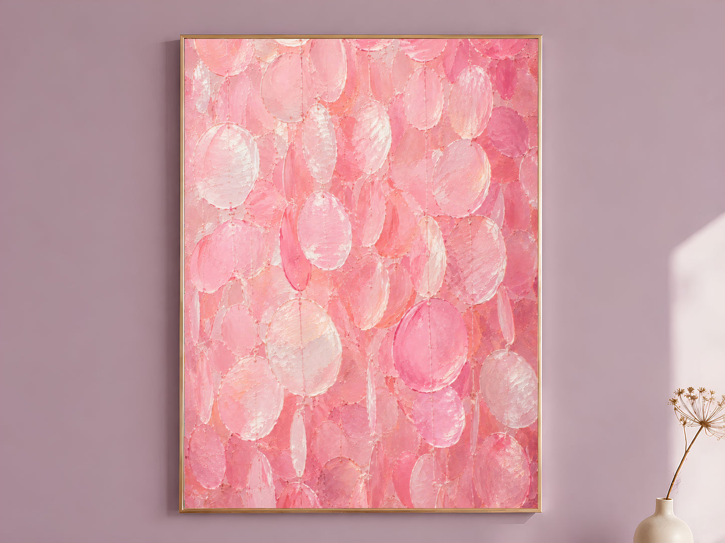 Pink capiz shell wall art print in a gold frame on a soft mauve wall with a dried flower stem beside it, showing full candy pink and pearl impasto texture
