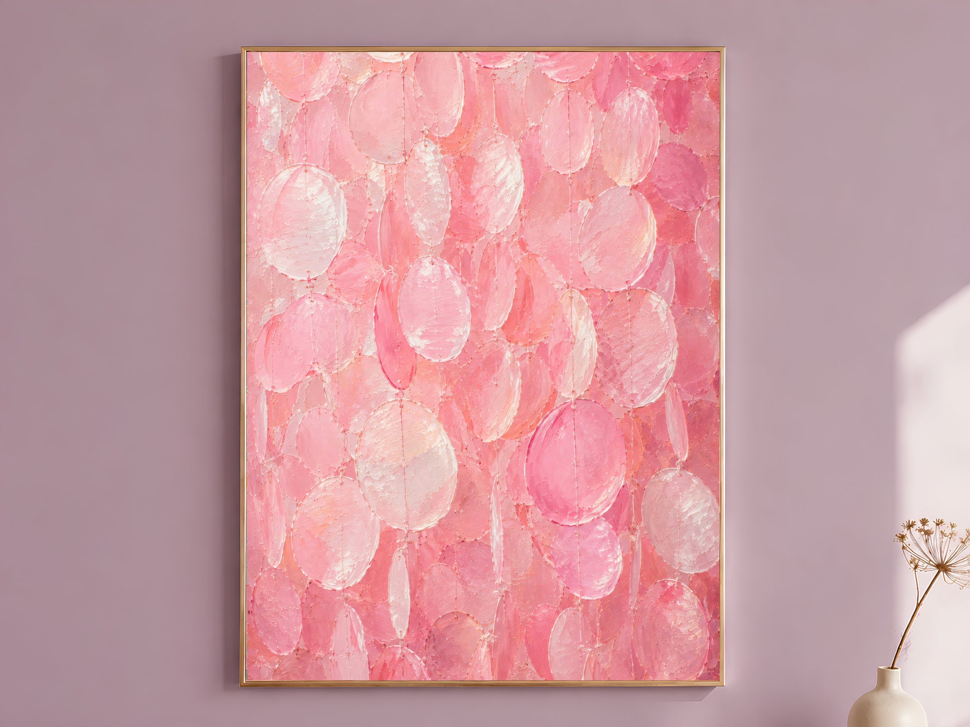 Pink capiz shell wall art print in a gold frame on a soft mauve wall with a dried flower stem beside it, showing full candy pink and pearl impasto texture
