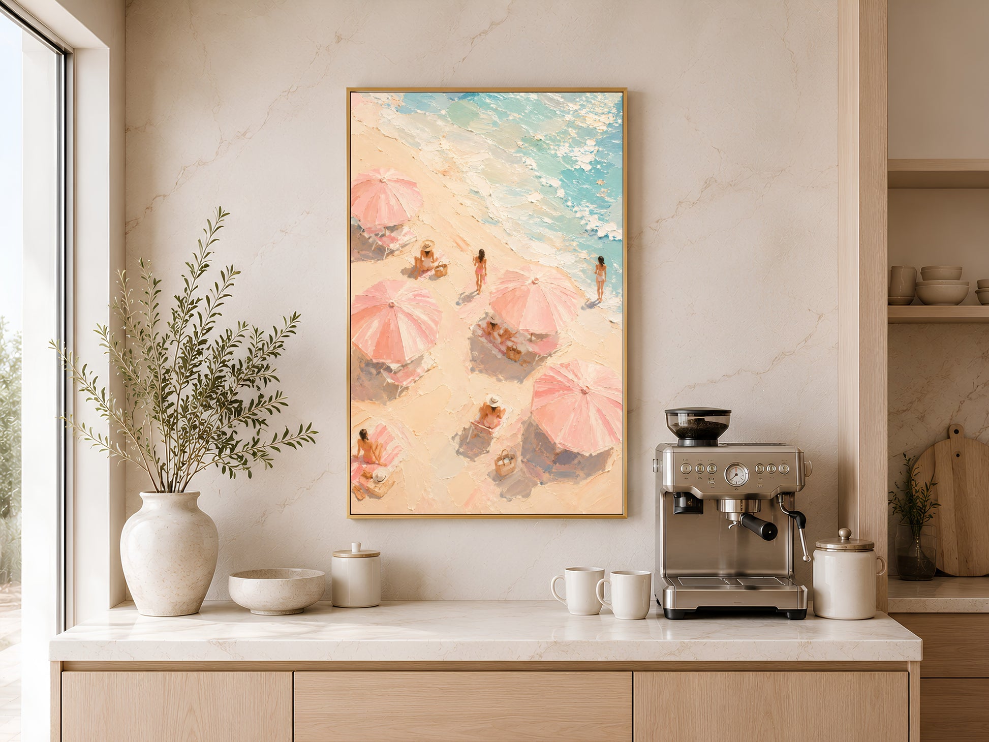 Beach umbrella aerial print in gold frame above a wooden sideboard with coffee machine in a warm neutral kitchen