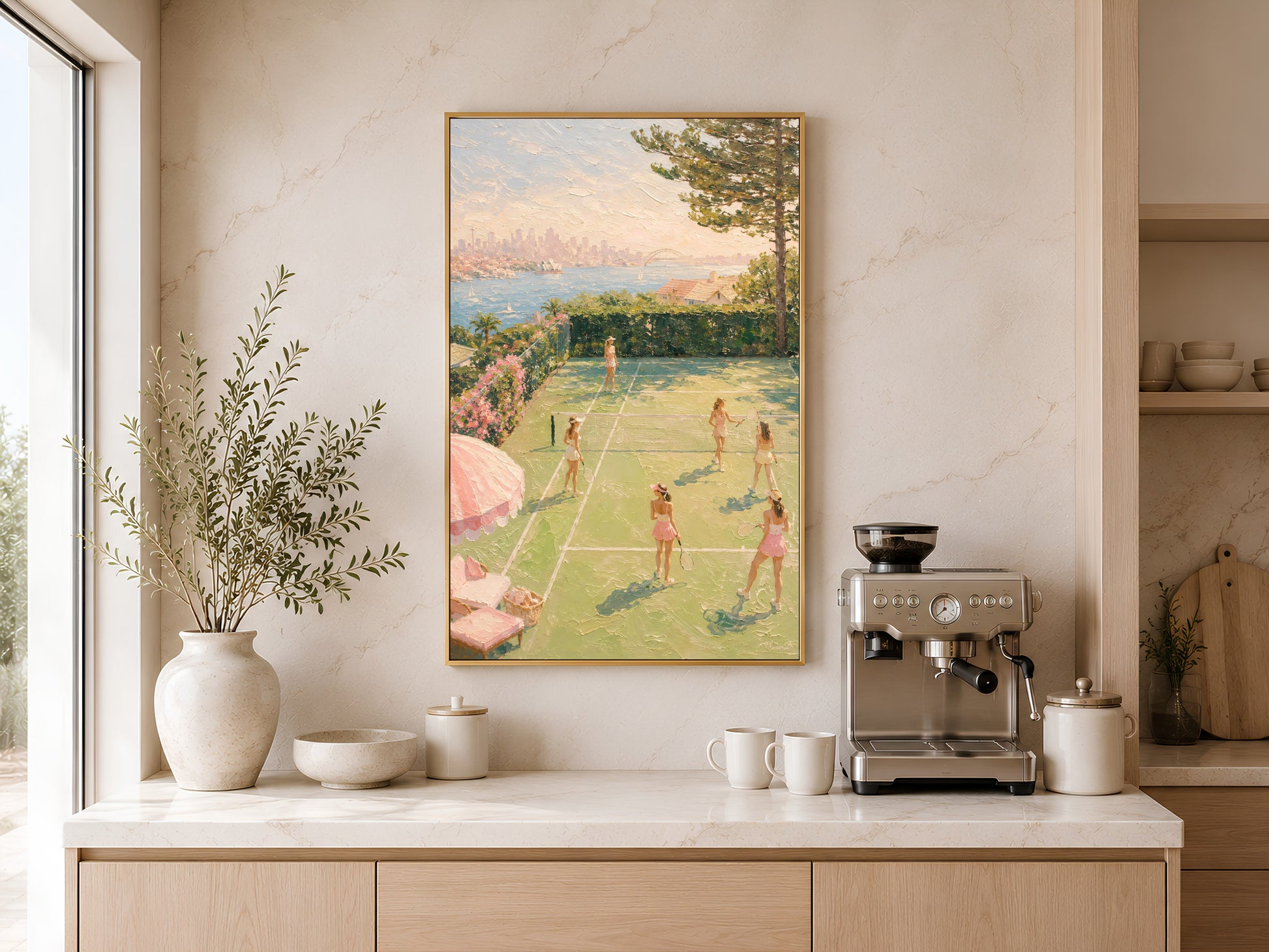 Tennis court oil painting print in gold frame above a wooden sideboard with coffee machine in a warm neutral kitchen
