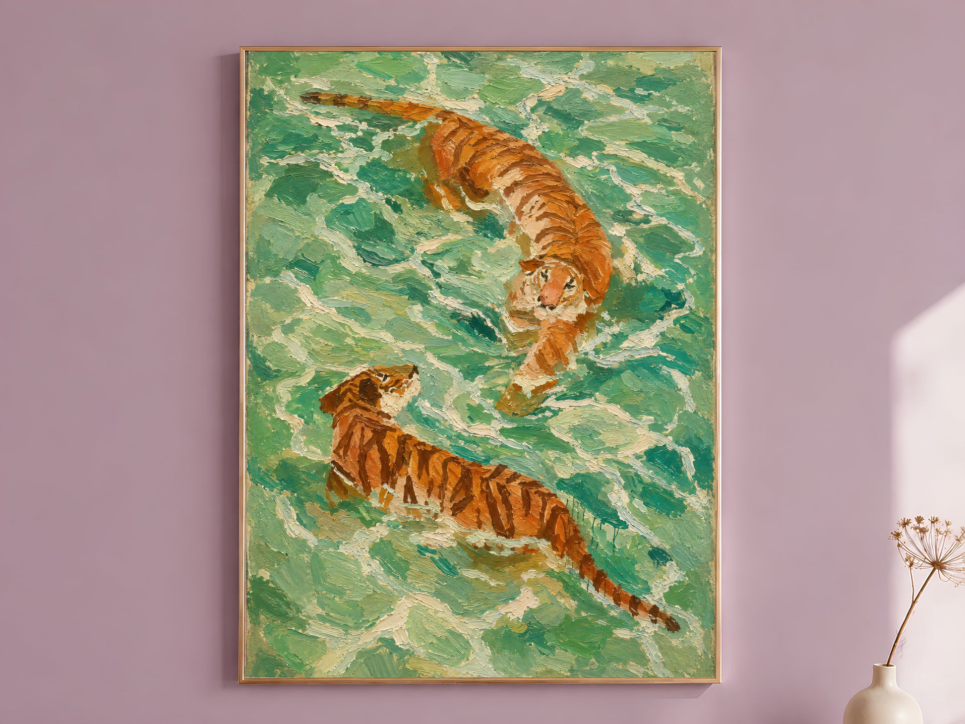 Aerial swimming tigers wall art in a gold frame on a dusty mauve wall with a dried allium stem, showing two amber and rust-striped tigers swimming through swirling emerald, jade, and cream impasto water brushstrokes
