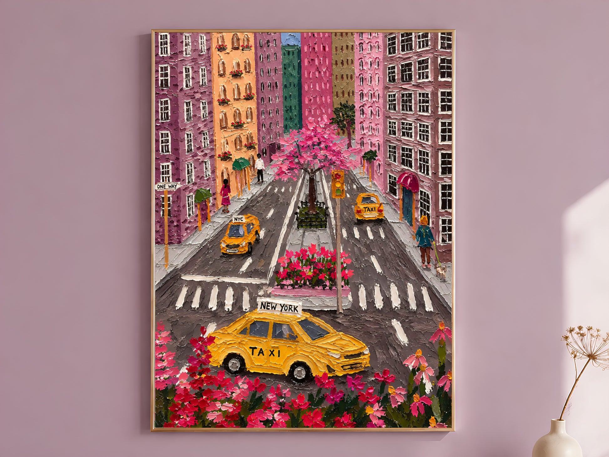 Colorful NYC taxi aerial impasto wall art in gold frame on mauve wall with dried flower stems
