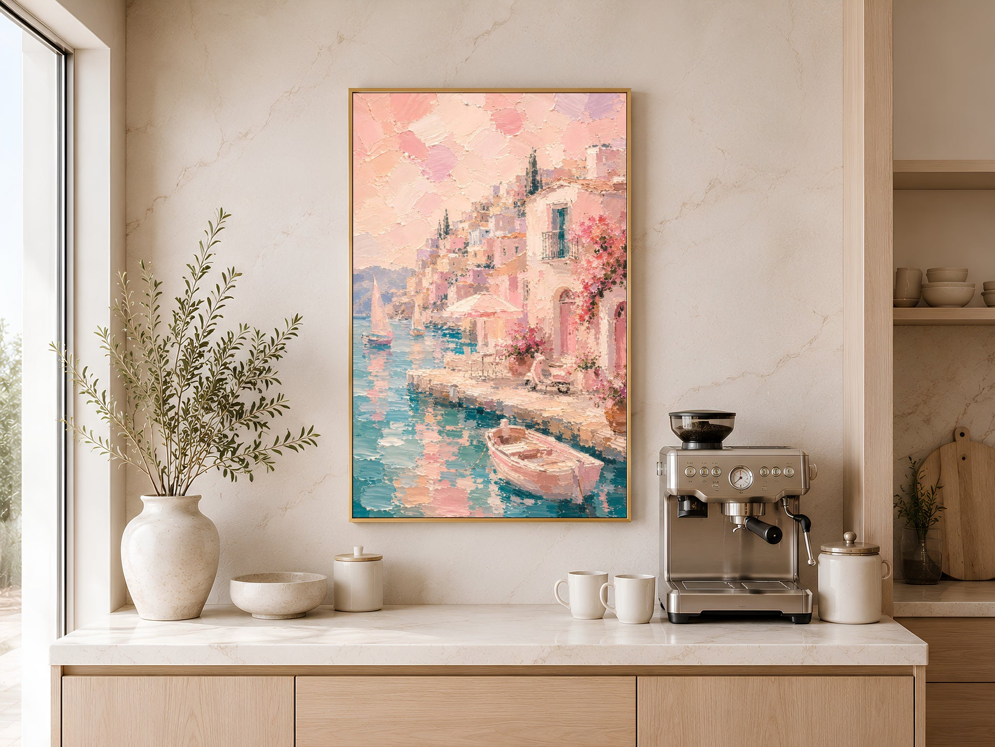 Pink Mediterranean wall art in gold frame above a wooden sideboard with coffee machine in a warm neutral kitchen