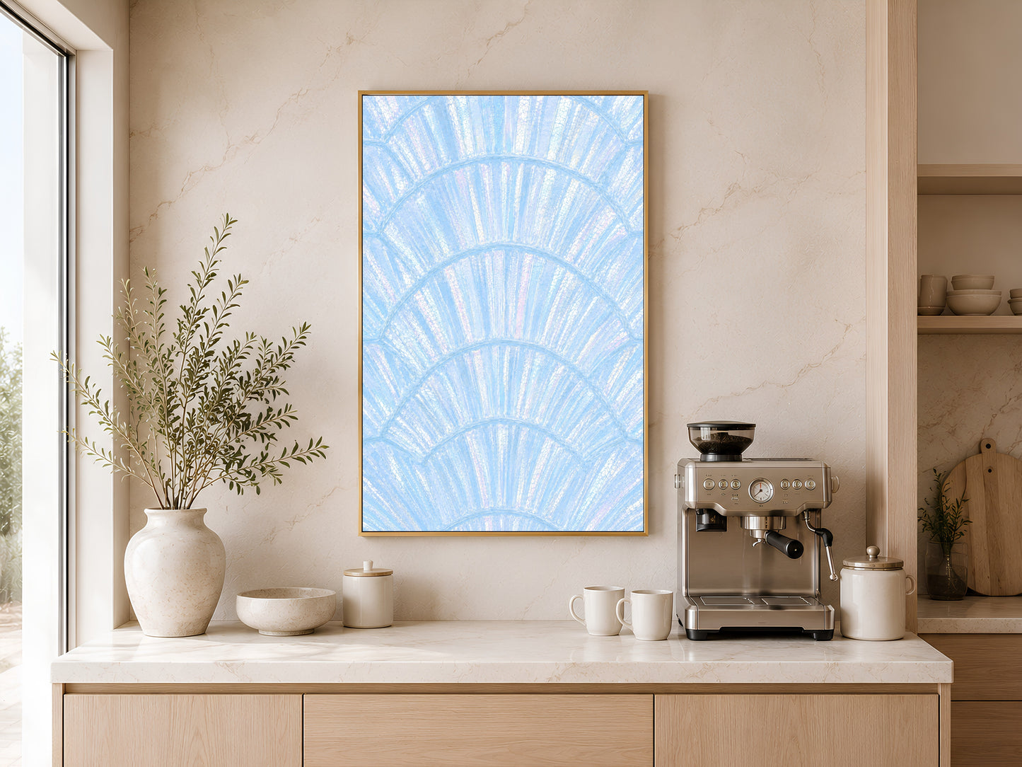 Blue capiz shell coastal art in gold frame above a wooden sideboard with coffee machine in a warm neutral kitchen