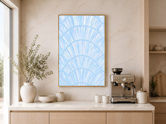 Blue capiz shell coastal art in gold frame above a wooden sideboard with coffee machine in a warm neutral kitchen