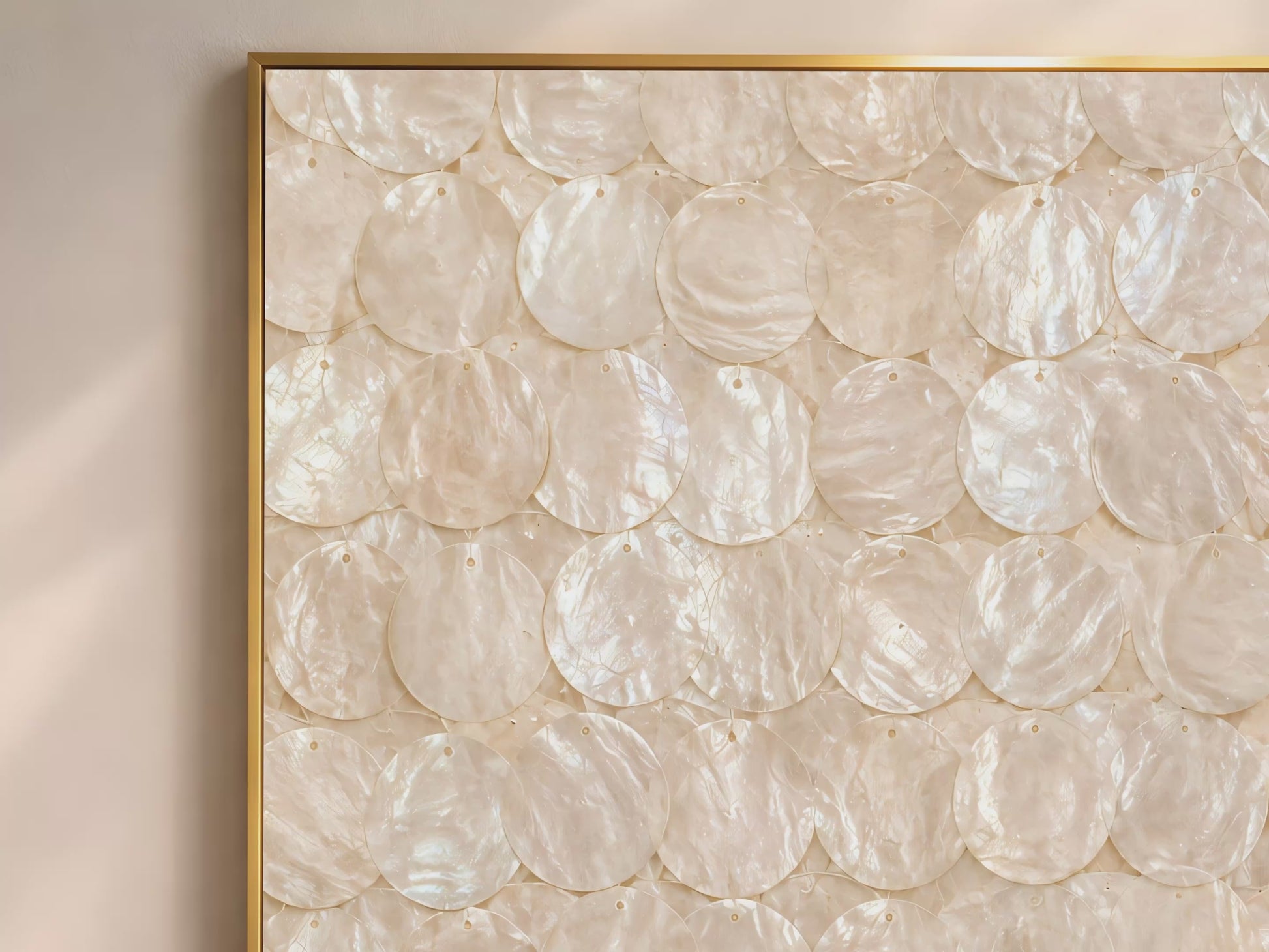 Capiz shell wall art video mockup thumbnail showing a close-up of the overlapping iridescent ivory and cream shell disc pattern in a gold frame against a warm neutral interior

