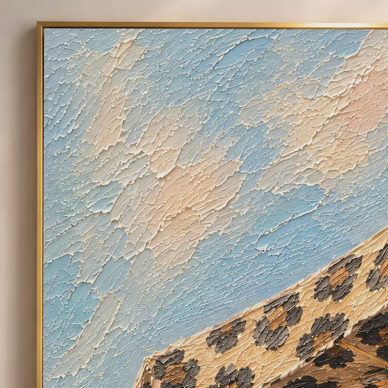 Close-up macro detail of leopard print beach umbrella impasto painting texture in caramel, brown and black against soft sky blue (video thumbnail)
