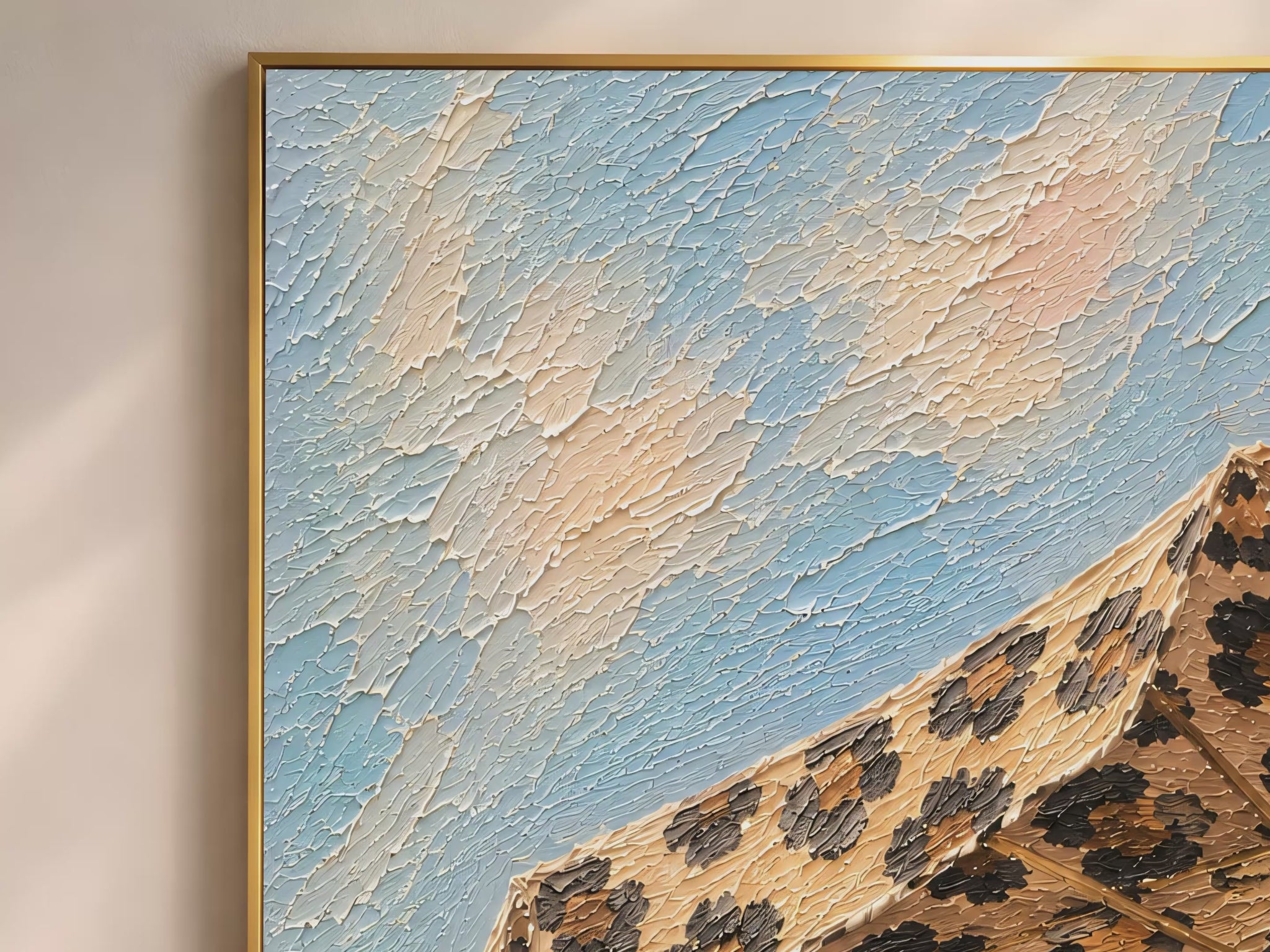 Close-up macro detail of leopard print beach umbrella impasto painting texture in caramel, brown and black against soft sky blue (video thumbnail)

