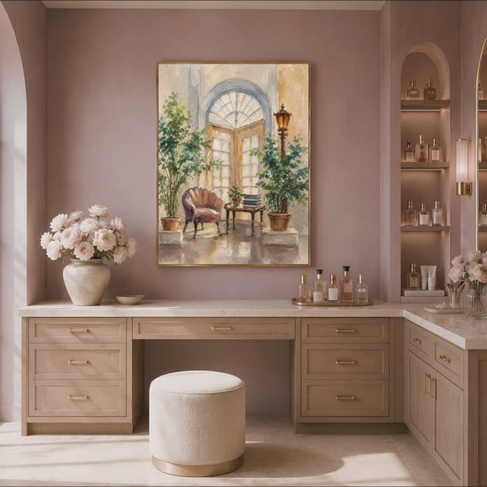 Mediterranean courtyard wall art in a gold frame above a mauve wall in a dressing area with a vanity and stool
