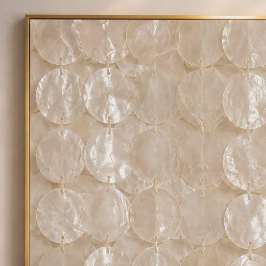Capiz shell wall art video mockup thumbnail showing the full pattern of translucent ivory shell discs strung in vertical rows in a gold frame against a warm neutral interior wall
