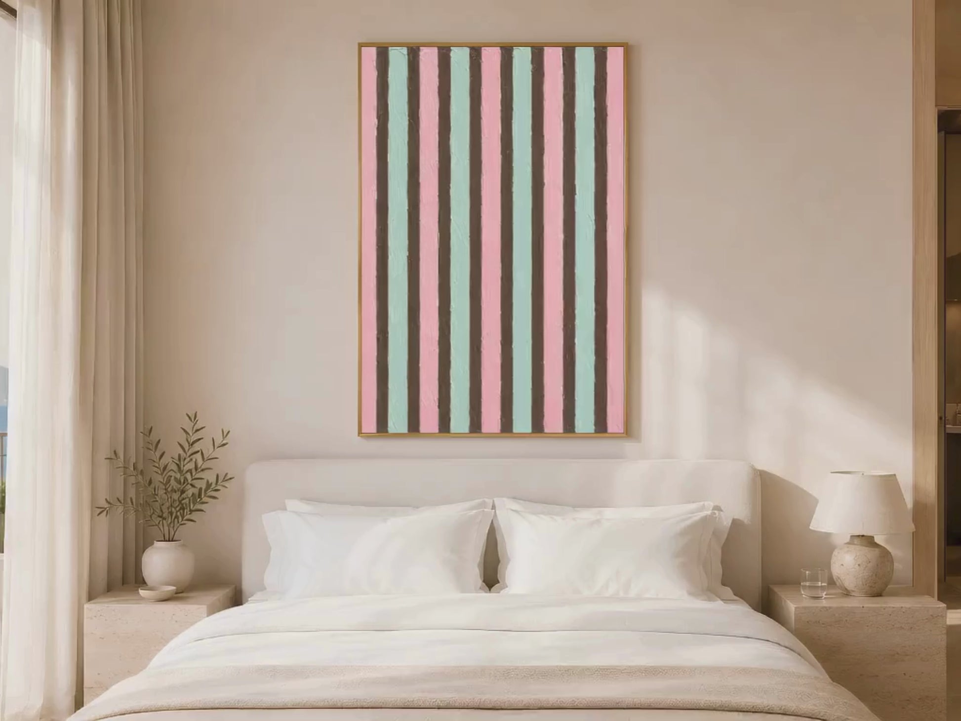 Pink mint candy stripe wall art in gold frame above white bed in warm neutral bedroom with soft lighting 