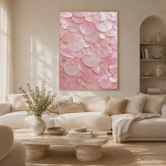 Video preview of a framed pink shell print displayed in a bright living room with a sofa and armchairs.